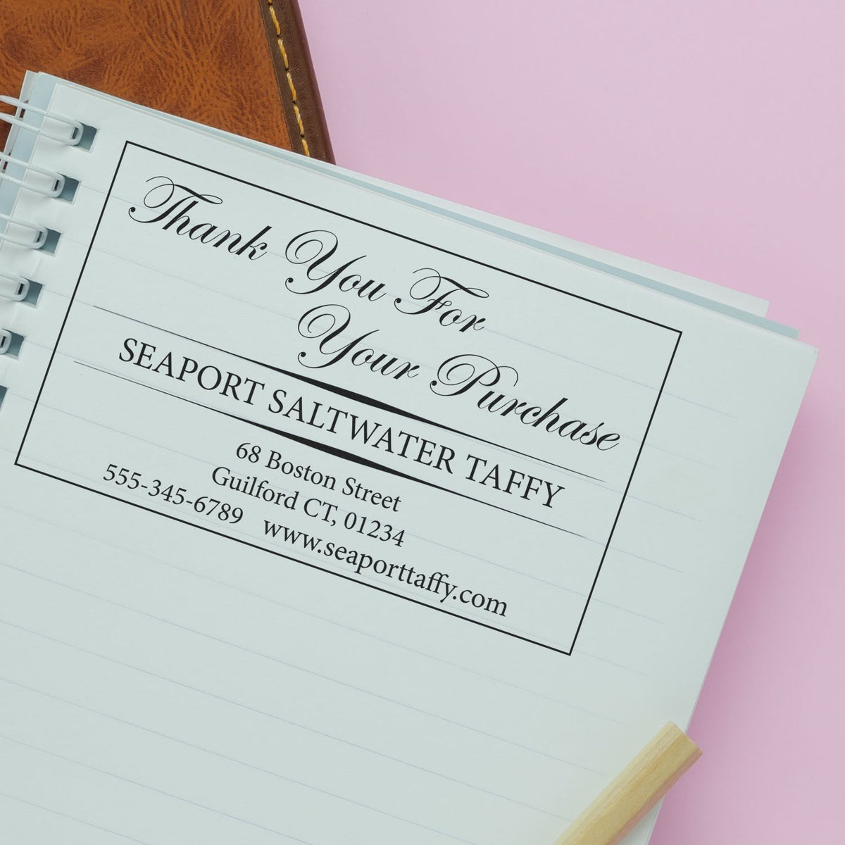 Thank you message on Seaport Saltwater Taffy notepad, thanking customers for their purchase with contact details, phone and website.