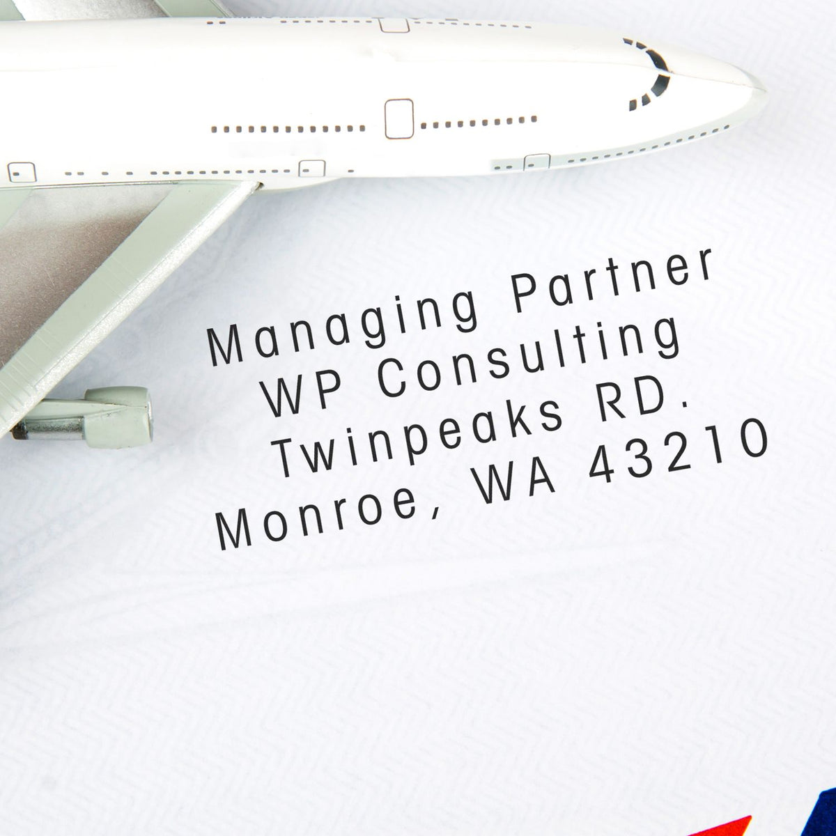 Airplane exterior with text: Managing Partner, WP Consulting, RD Twinpeaks, Monroe, WA 43210.