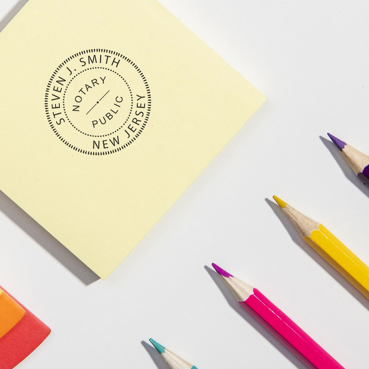 Notary stamp on yellow note reading Notary Public by Steven J. Smith, with colored pencilspaper verification concept