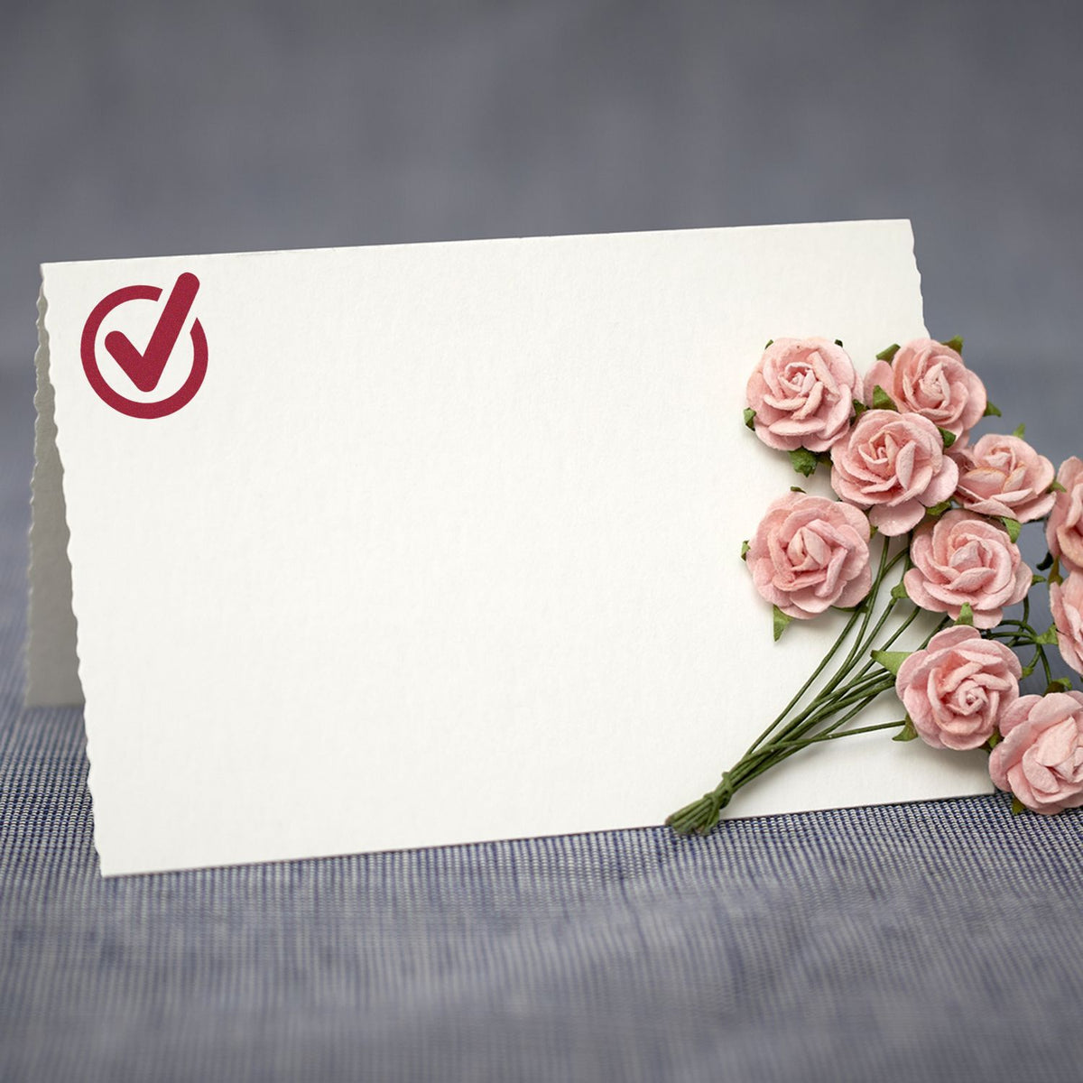 Blank greeting card with red checkmark icon and pink roses, symbolizing confirmation or thank-you message for events
