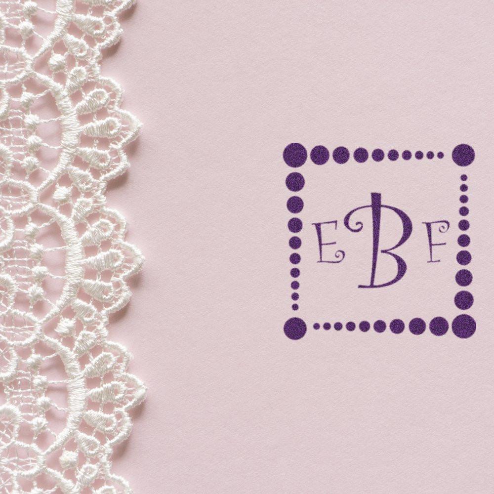 Custom EBF monogram rubber stamp on pink stationery with lace, ideal for wedding invitations and personalized paper goods.