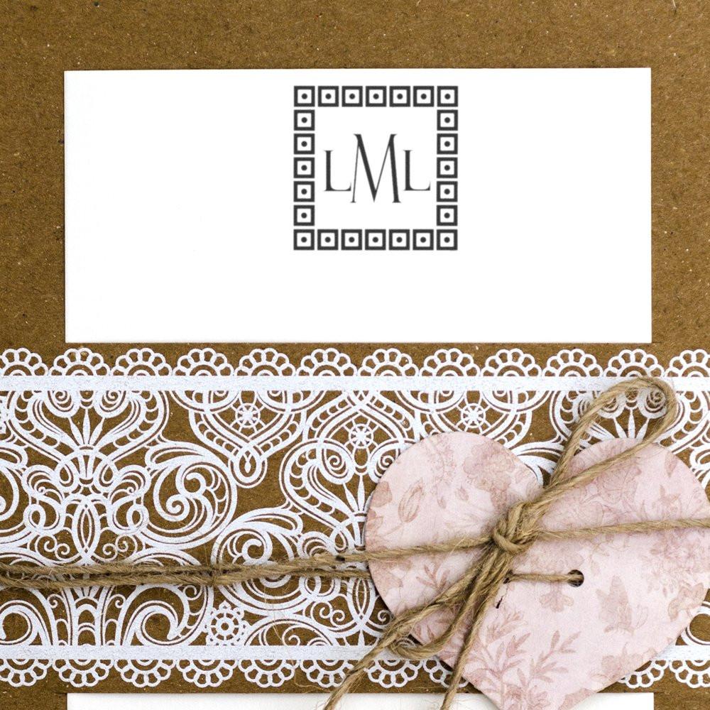 Personalized monogram rubber stamp on kraft paper gift wrap with lace and heart embellishments