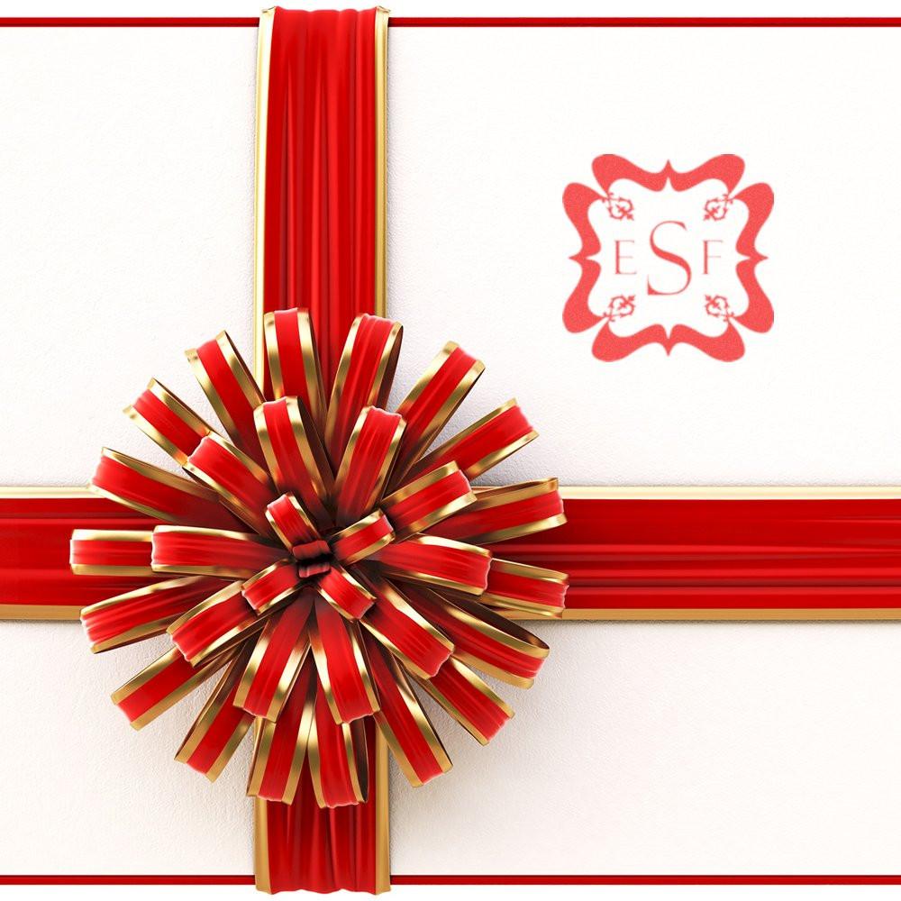 Custom rubber stamp monogram logo on red-and-gold gift wrap with bow, ideal for personalized packaging and branding.