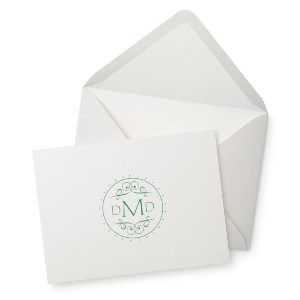 Custom monogram rubber stamp on white envelope and card for personalized stationery and mailings.