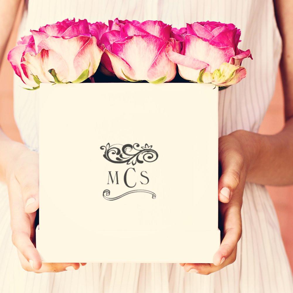 MCS gift box held by hands with a top bouquet of pink and white roses, wedding or Valentines flower arrangement gift delivery