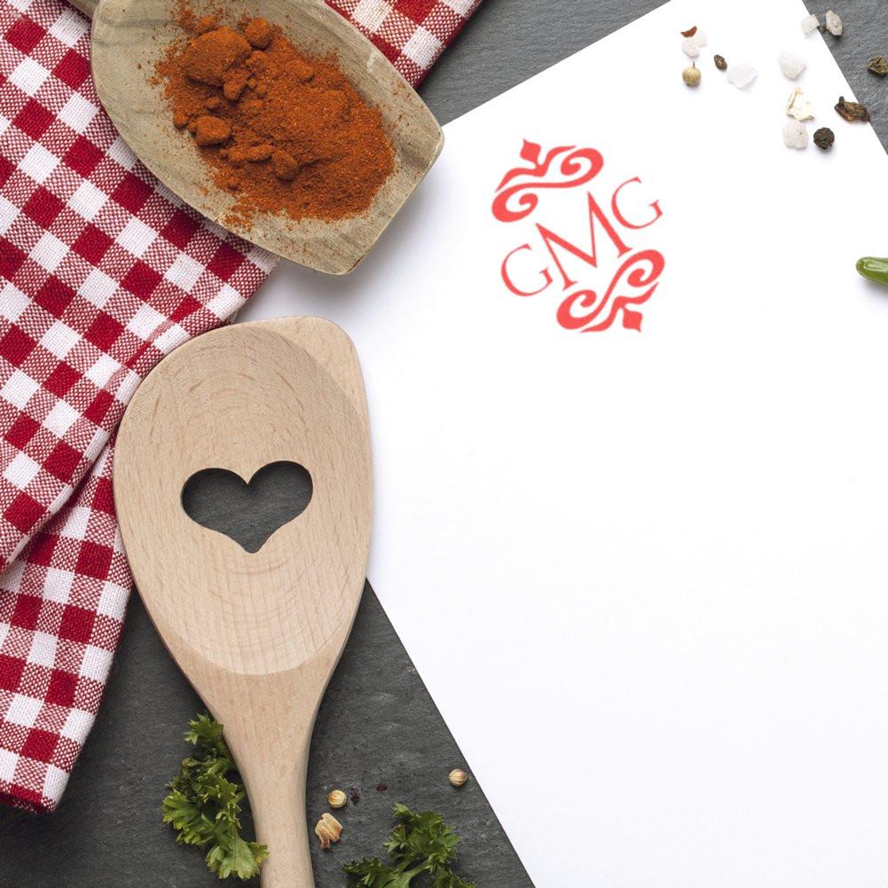 Custom monogram rubber stamp impression on white paper, with decorative CMG initials in red for personalized branding.