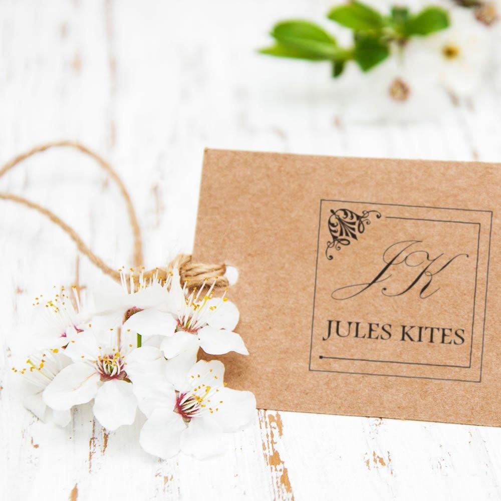 Custom monogram rubber stamp on kraft wedding stationery with floral accents and personalized name Jules Kites.