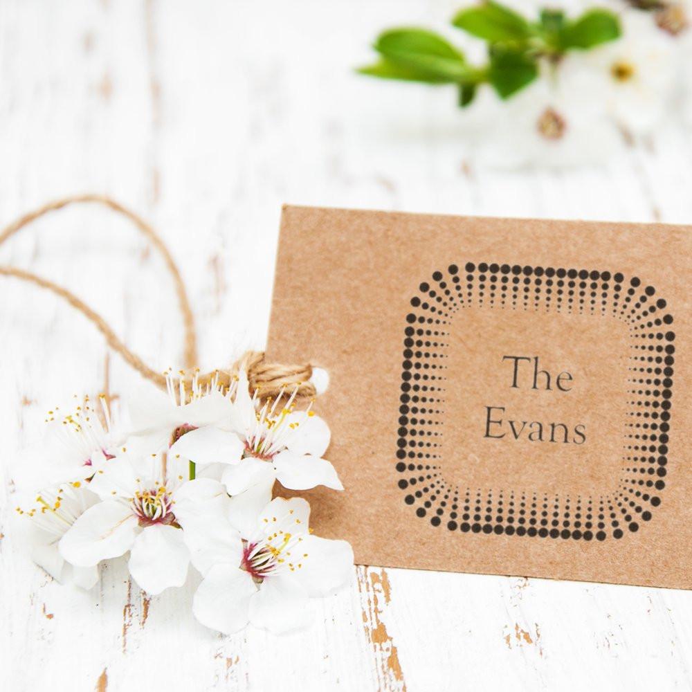 Personalized rubber stamp for The Evans, shown on a kraft card with dotted square border for custom wedding or packaging branding.