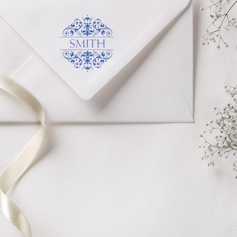 Custom rubber stamp monogram on a wedding envelope for personalized invitations and elegant stationery.