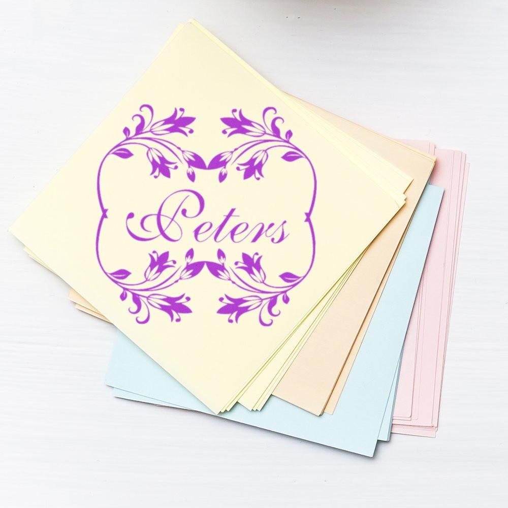 Custom floral monogram rubber stamp with the name Peters, stamped on pastel cards for wedding invitations and stationery branding.