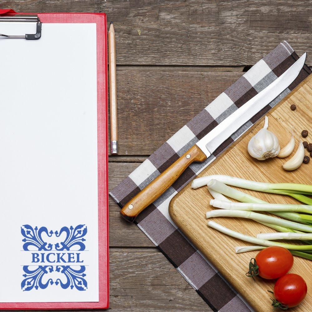 Custom rubber stamp logo on clipboard, showcasing branded stationery for restaurant packaging and food business marketing.