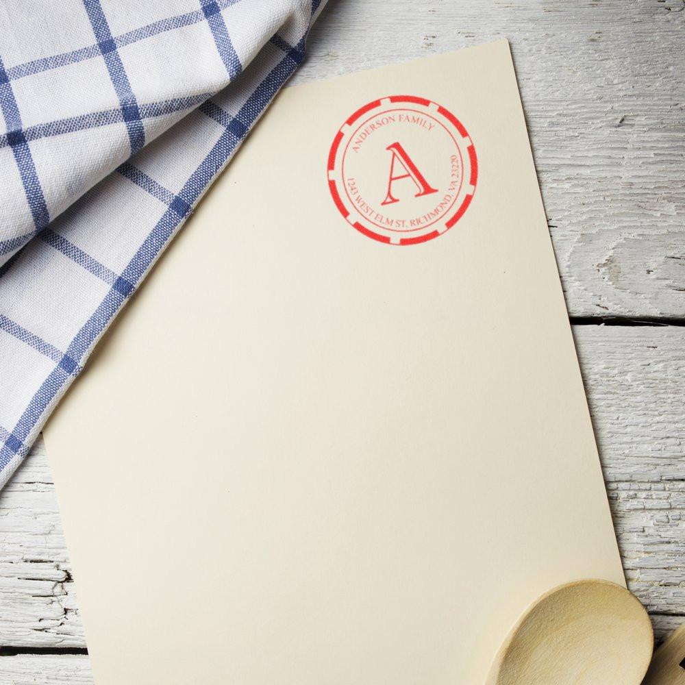 Custom family return address rubber stamp on cream stationery, perfect for personalized wedding or business mail.