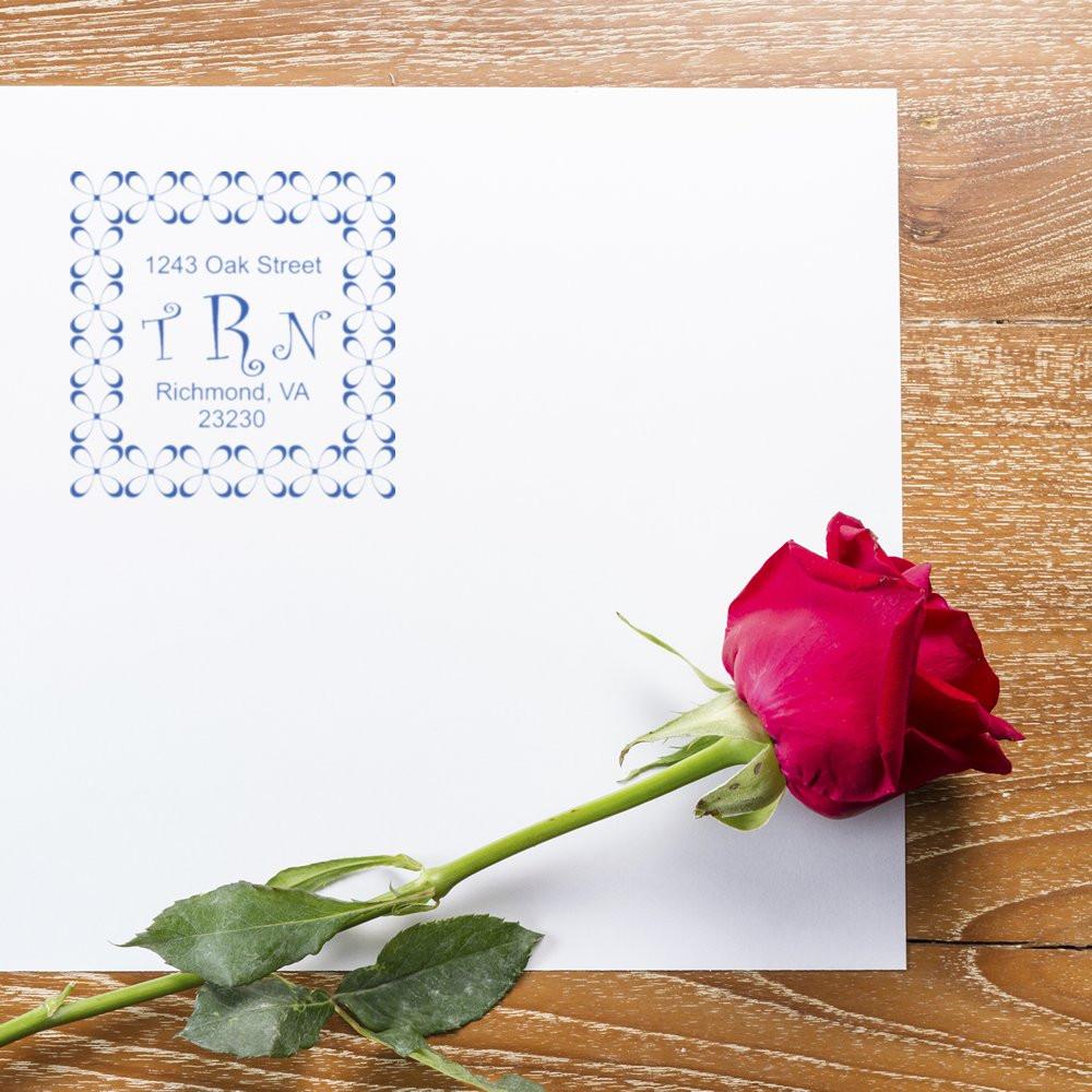 Custom monogram return address rubber stamp on white envelope, ideal for wedding stationery, invitations, and mail.
