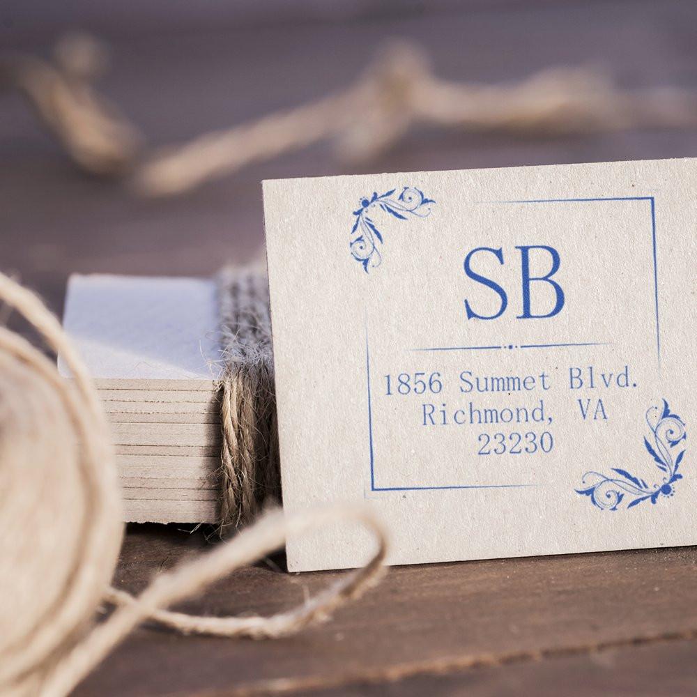 Elegant custom return address rubber stamp with SB initials and floral corner accents for wedding or business mail.