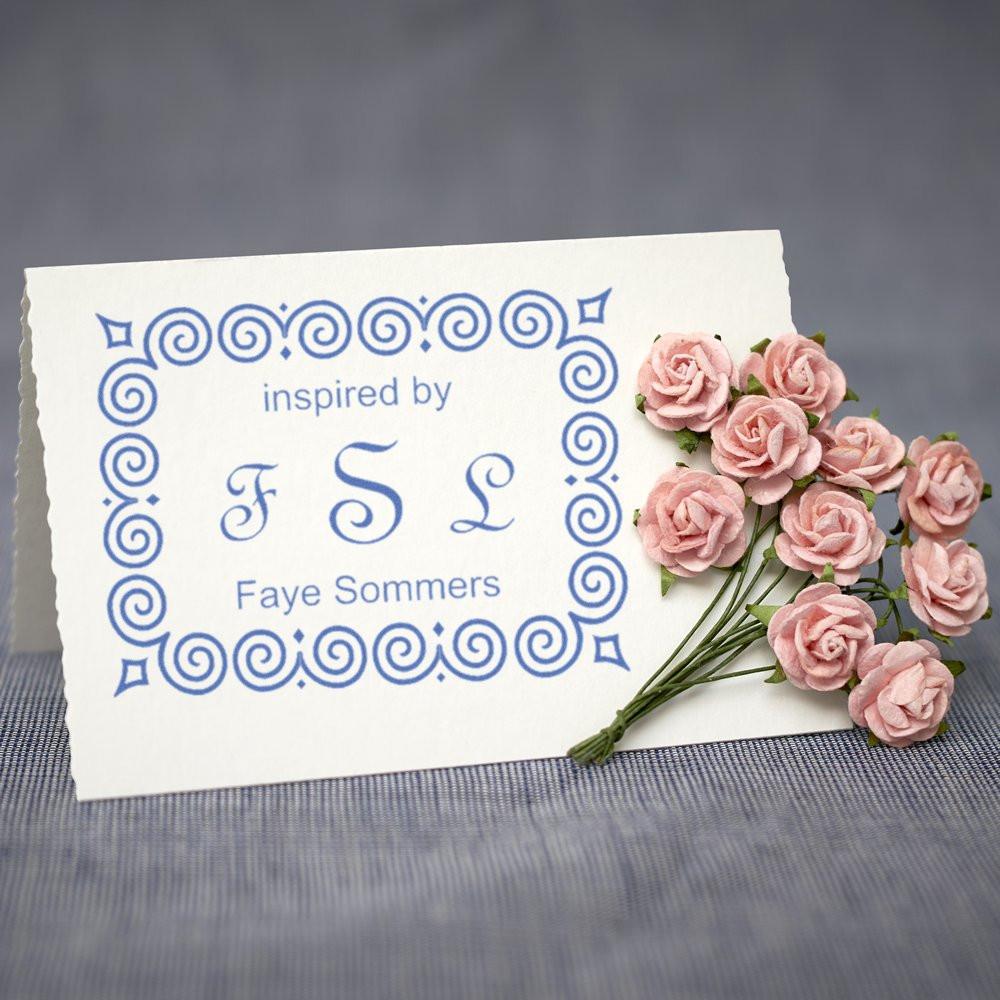 Custom rubber stamp sample with ornate monogram border and name, ideal for personalized stationery and branding.