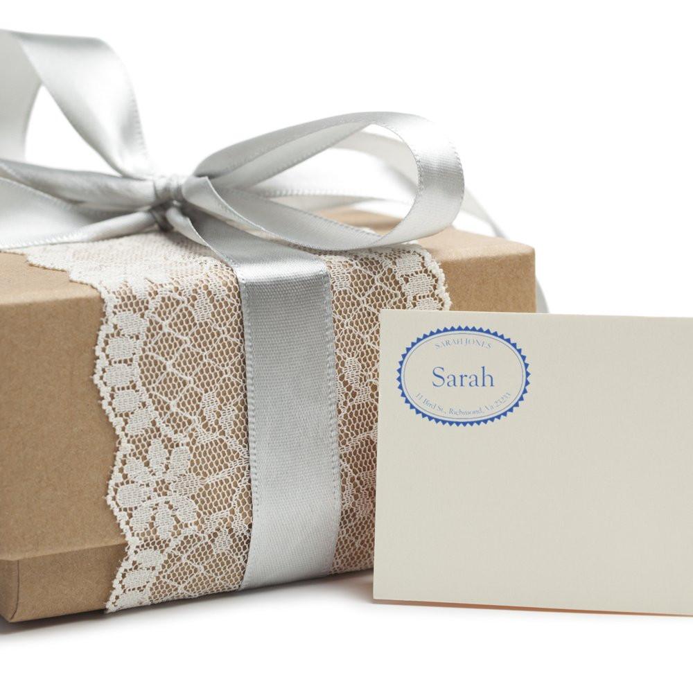 Personalized rubber stamp design for gift wrapping, shown on a kraft box with lace ribbon and a custom Sarah name card.