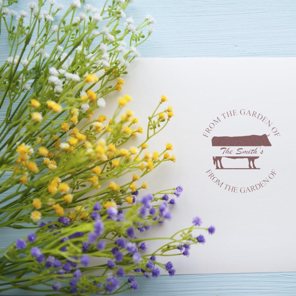 Personalized garden rubber stamp on white stationery with flowers, featuring From the Garden of The Smiths design.
