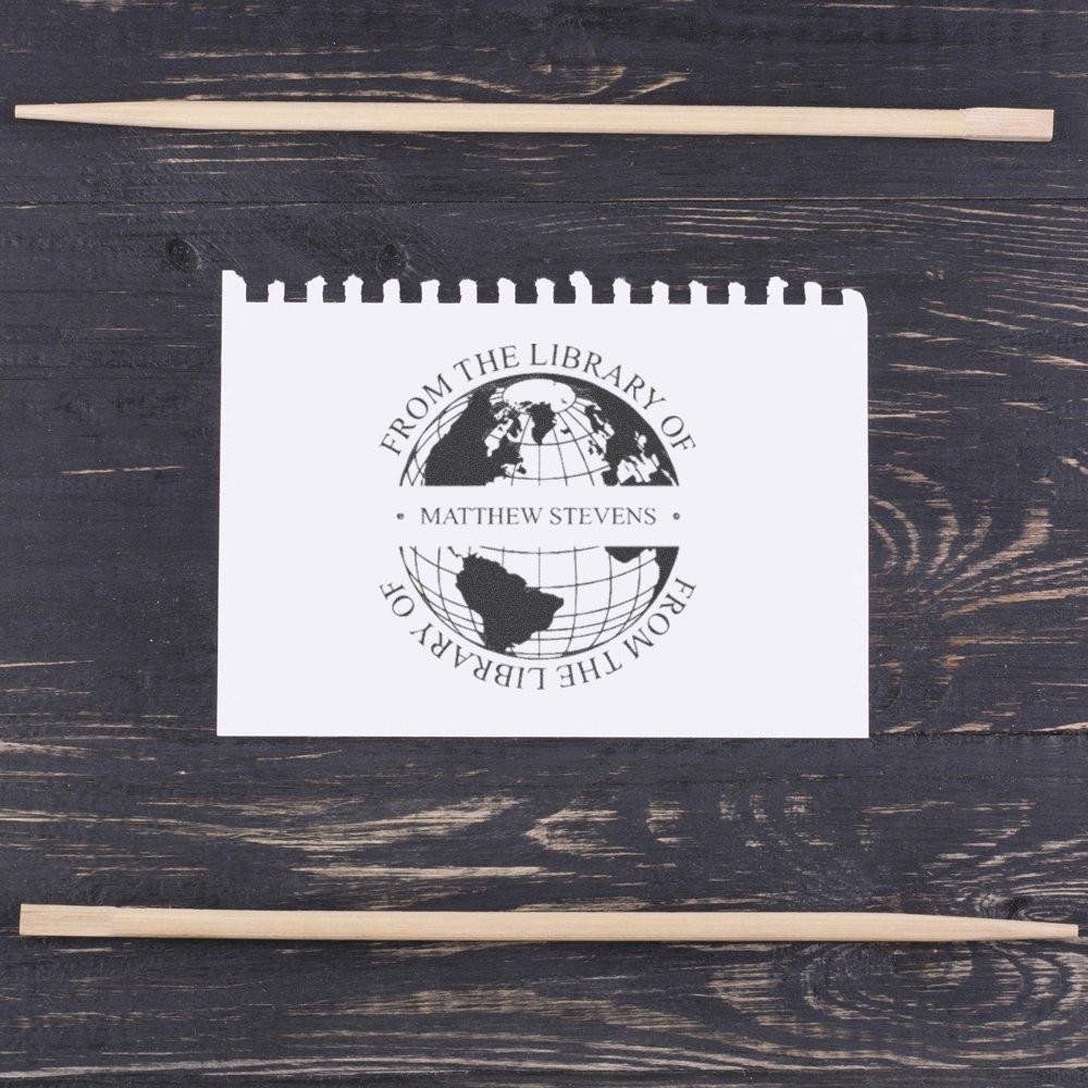 Custom library rubber stamp with wooden handle for marking books From the Library of Matthew Stevens.