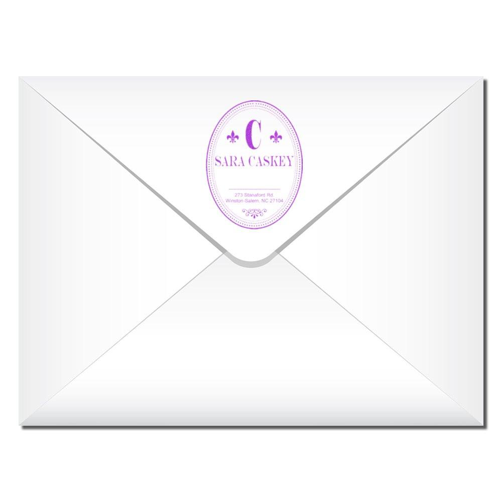 Custom return address rubber stamp with purple monogram on white envelope for personalized wedding stationery.