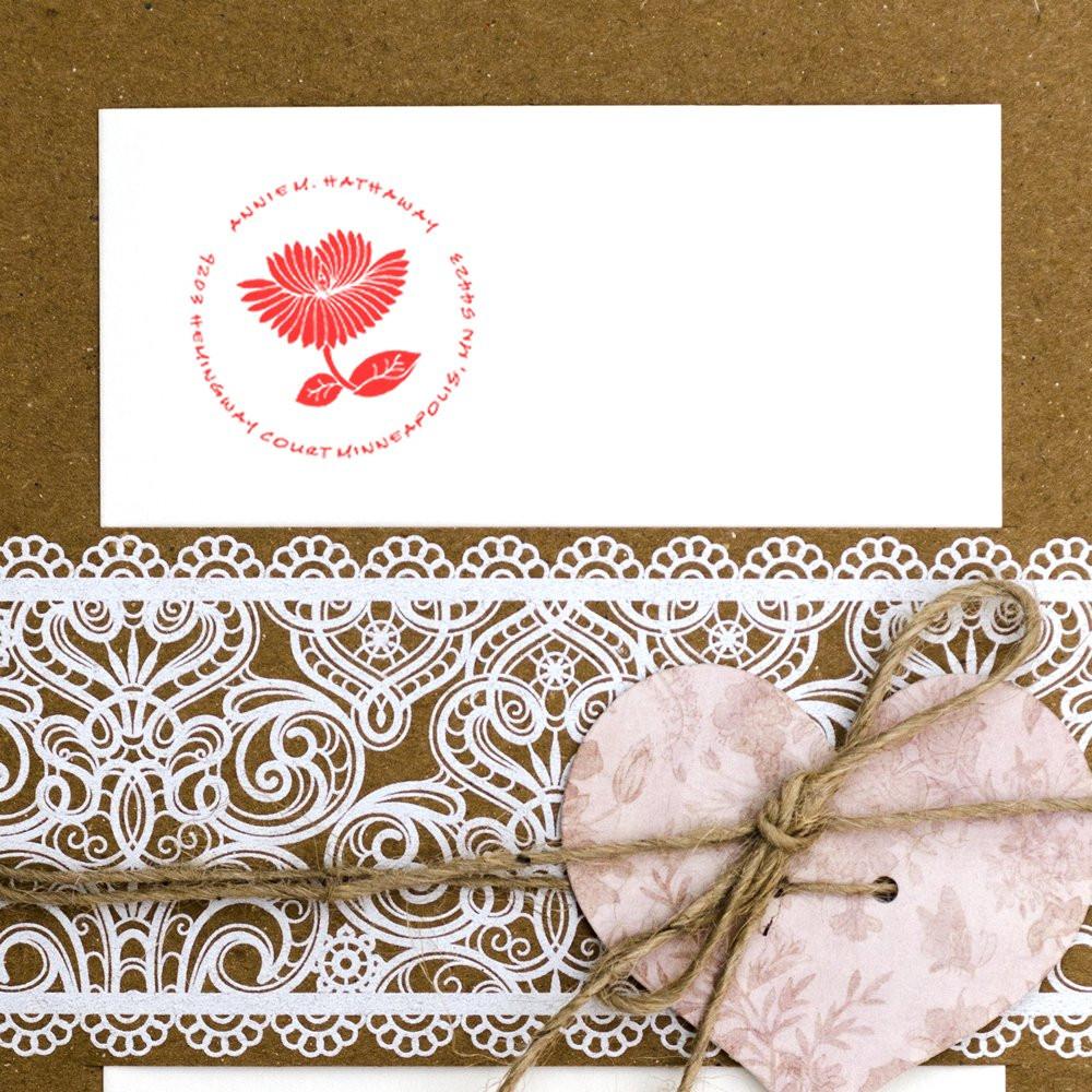 Custom floral rubber stamp on envelope with lace wrap and heart gift tag for handmade wedding stationery