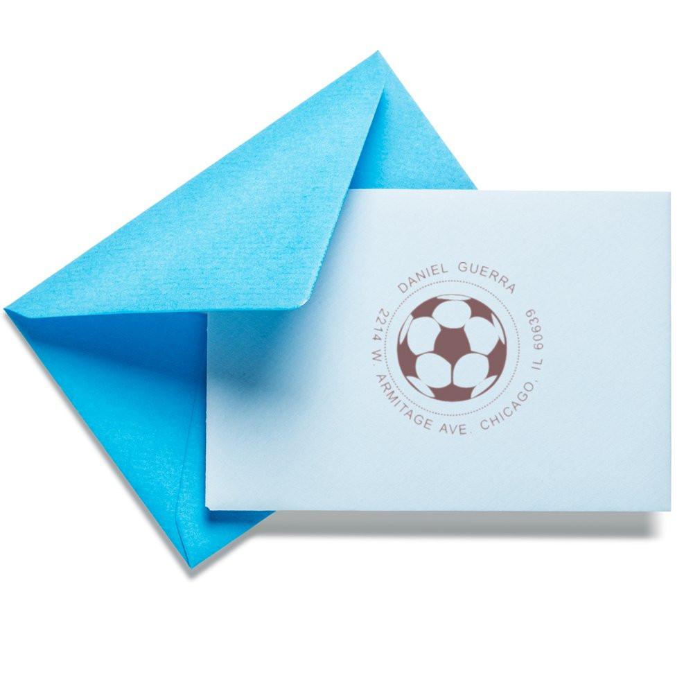 Custom rubber stamp return address on white envelope with blue liner, for personalized wedding or business stationery.