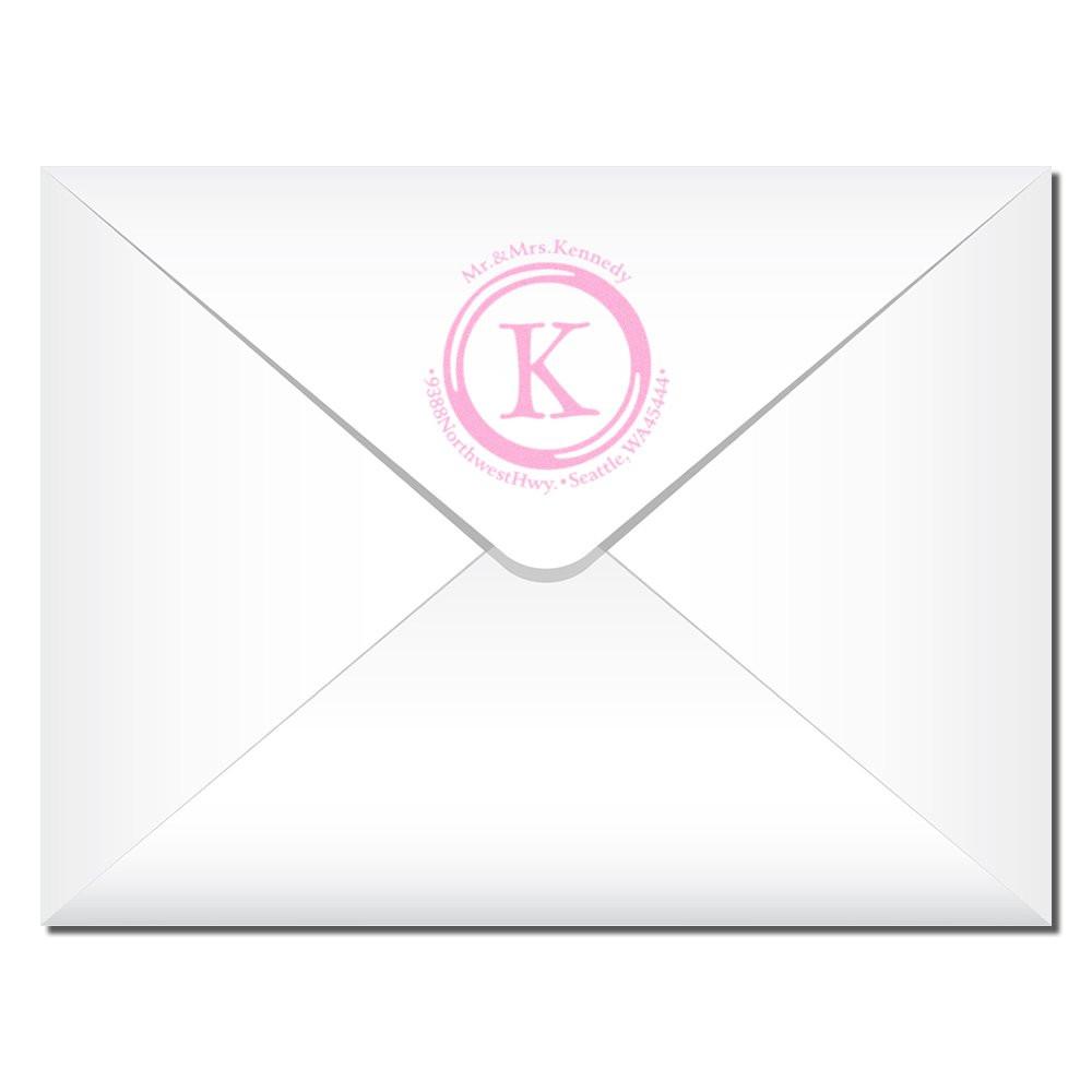 Personalized wedding event invitation envelope for Mr & Mrs Kennedy with K monogram logo and Seattle Washington address marking.