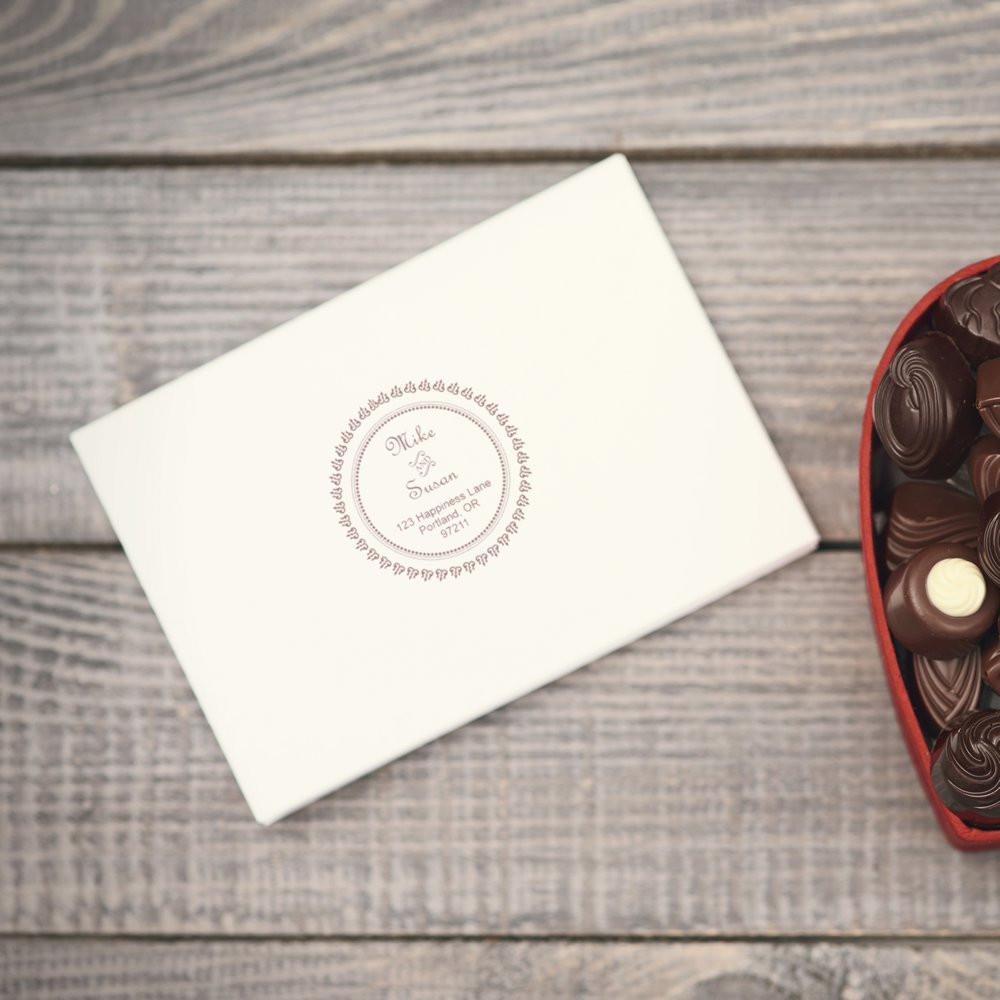 Custom rubber stamp on wedding envelope with monogram return address for personalized stationery, invitations, and gifts.