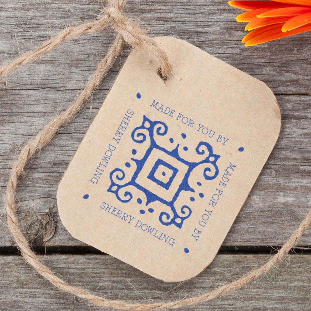 Personalized rubber stamp impression on kraft gift tag with blue decorative border and Made for You by Sherry Dowling text