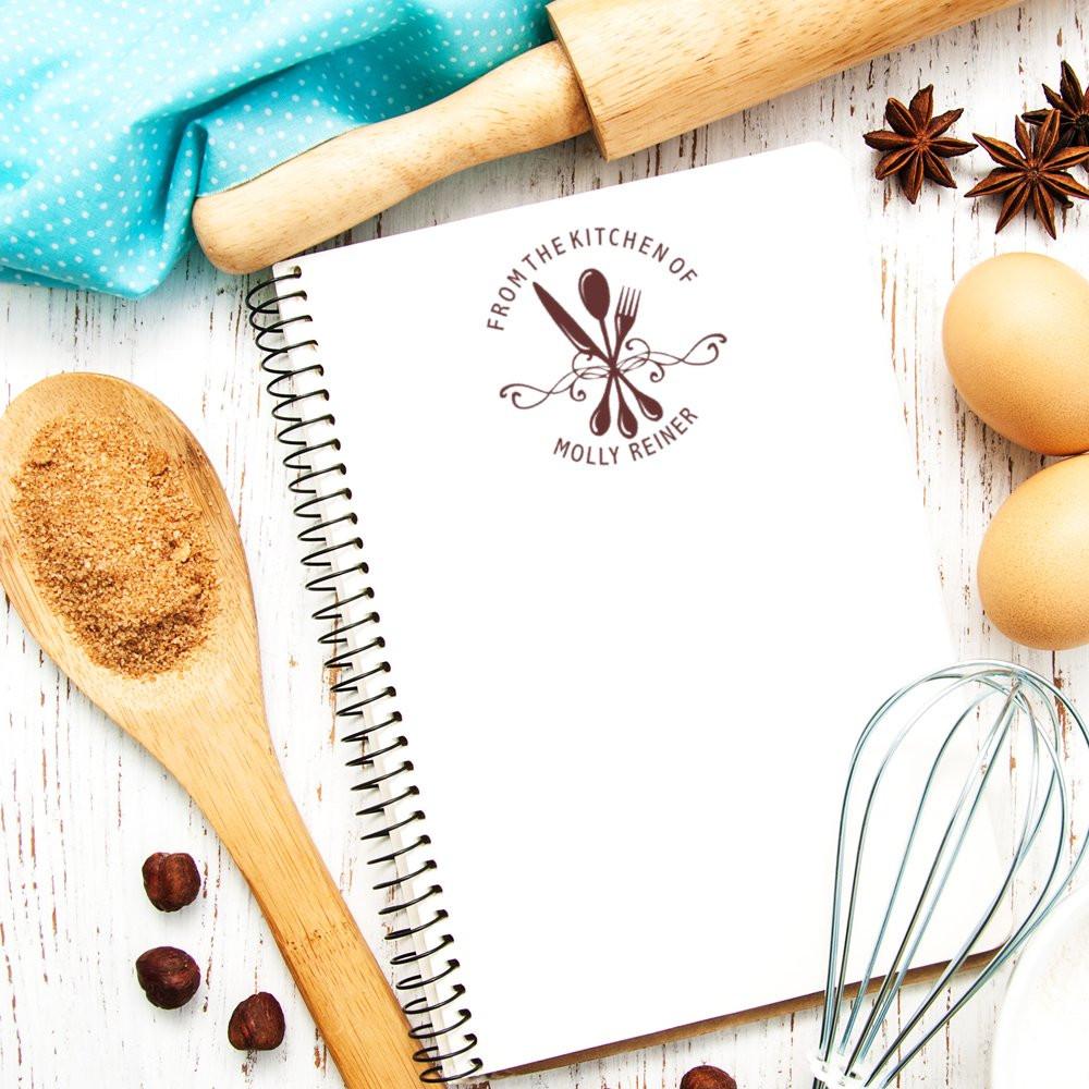 Custom kitchen rubber stamp for recipe notebooks with personalized From the Kitchen of utensil design.
