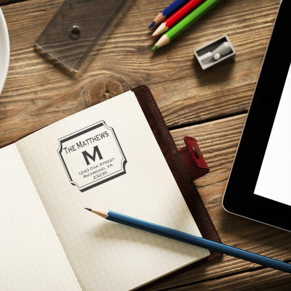Personalized address rubber stamp on notebook, ideal for return address labels, stationery, and small business use.