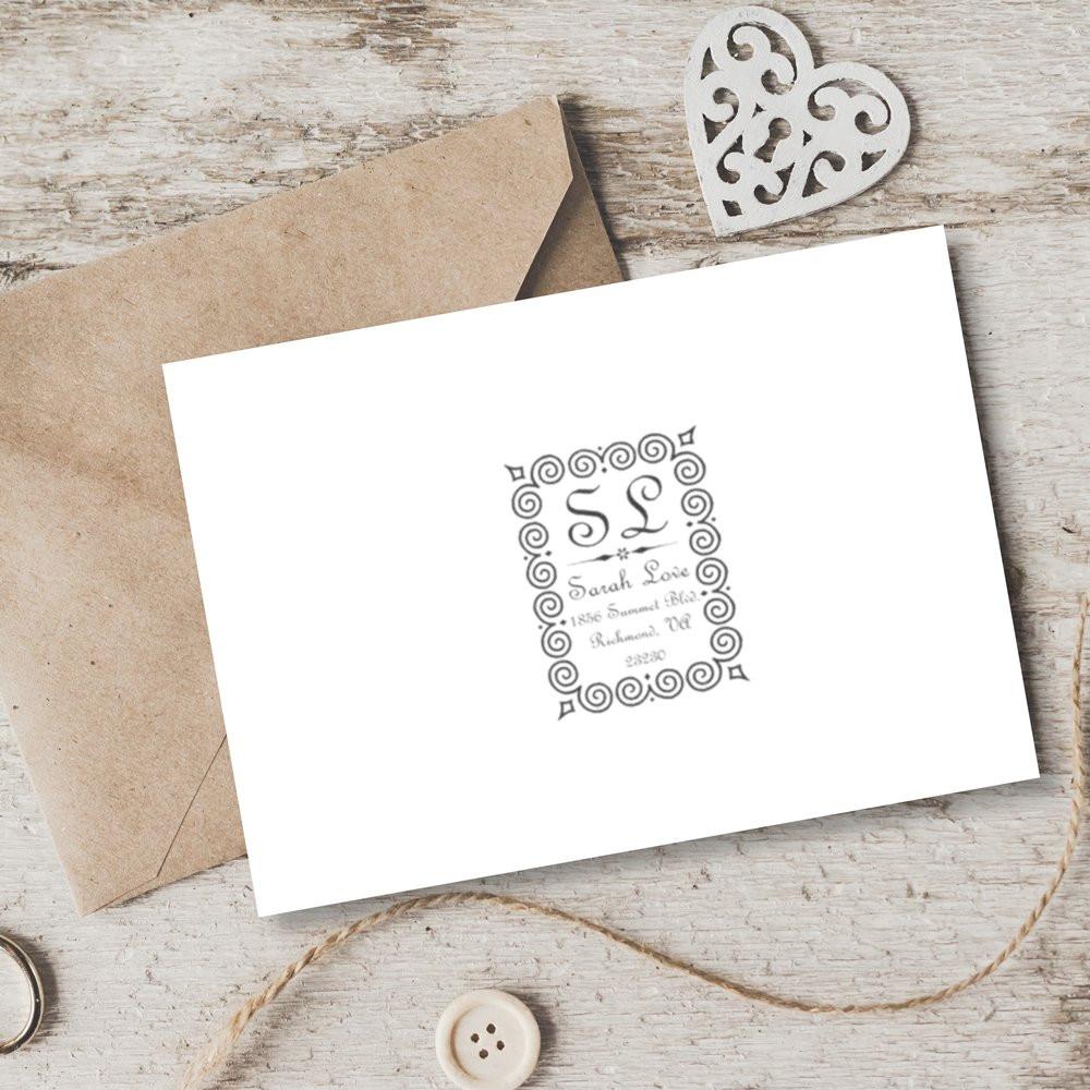 Custom rubber stamp impression on wedding stationery with ornate monogram, perfect for handmade invitations and thank-you cards.