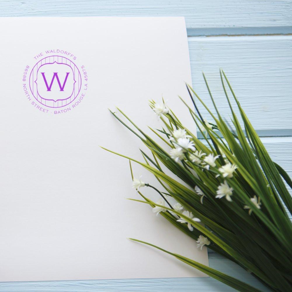 Purple custom rubber stamp logo on white stationery, featuring The Waldorffs monogram and Baton Rouge address.