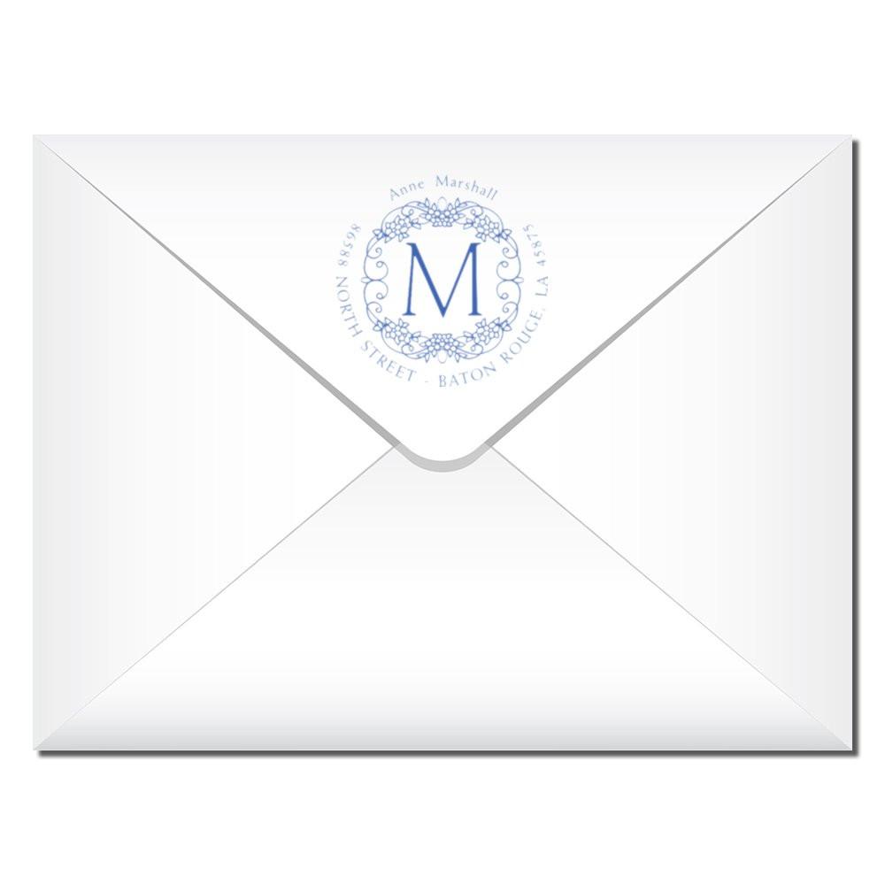 Custom monogram return address rubber stamp on a white envelope for elegant wedding or business mail.