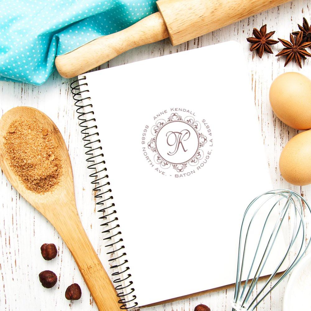 Custom monogram return address rubber stamp on notebook, perfect for personalized stationery, weddings, and handmade gifts.