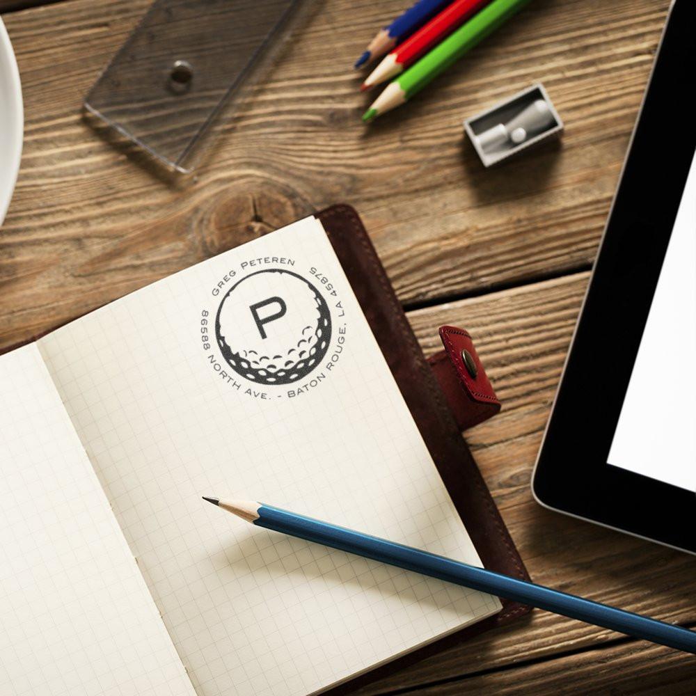 Personalized rubber stamp imprint in a planner notebook for custom branding and address labeling.