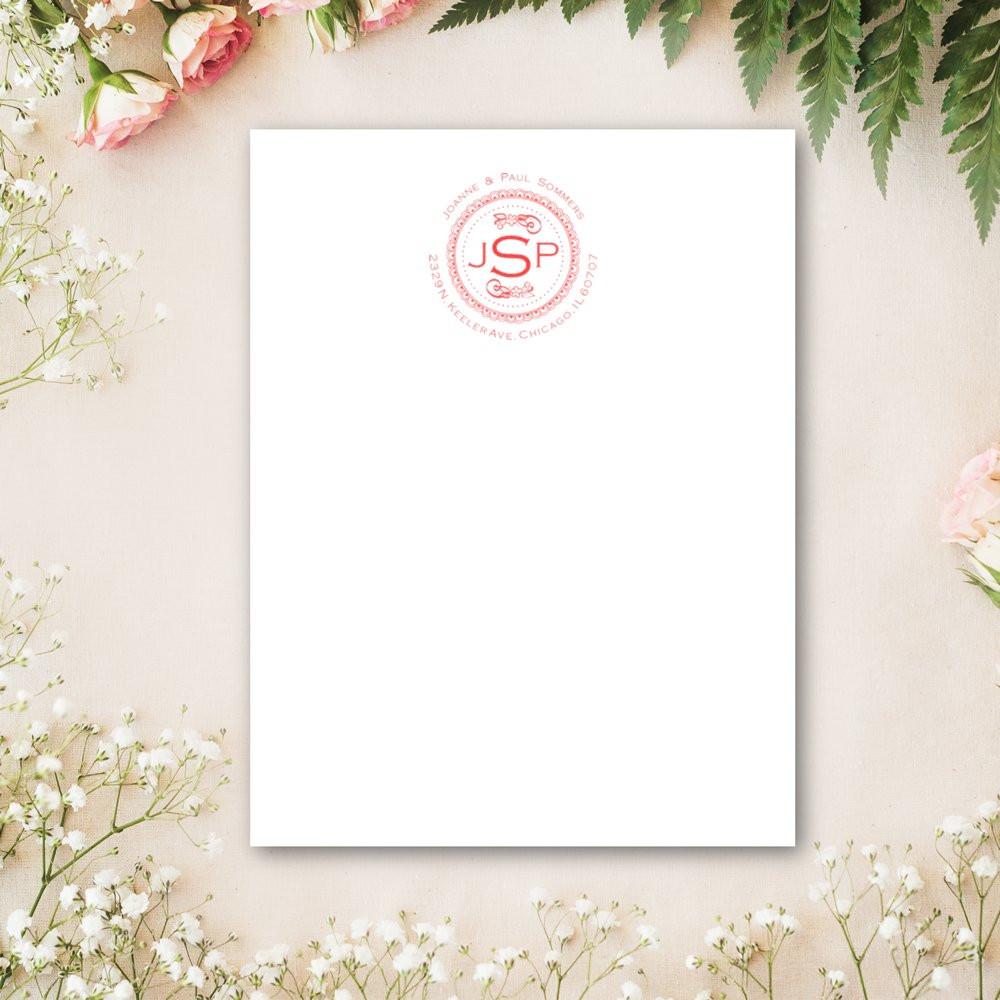 Blank wedding invitation card with red JSP logo seal, styled on white floral background for Chicago bridal event.