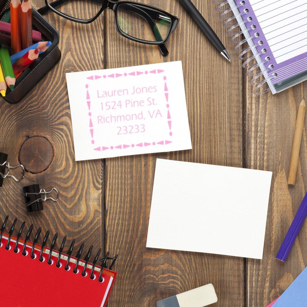 Personalized return address rubber stamp on desk stationery, ideal for mailing labels, invitations, and craft projects.