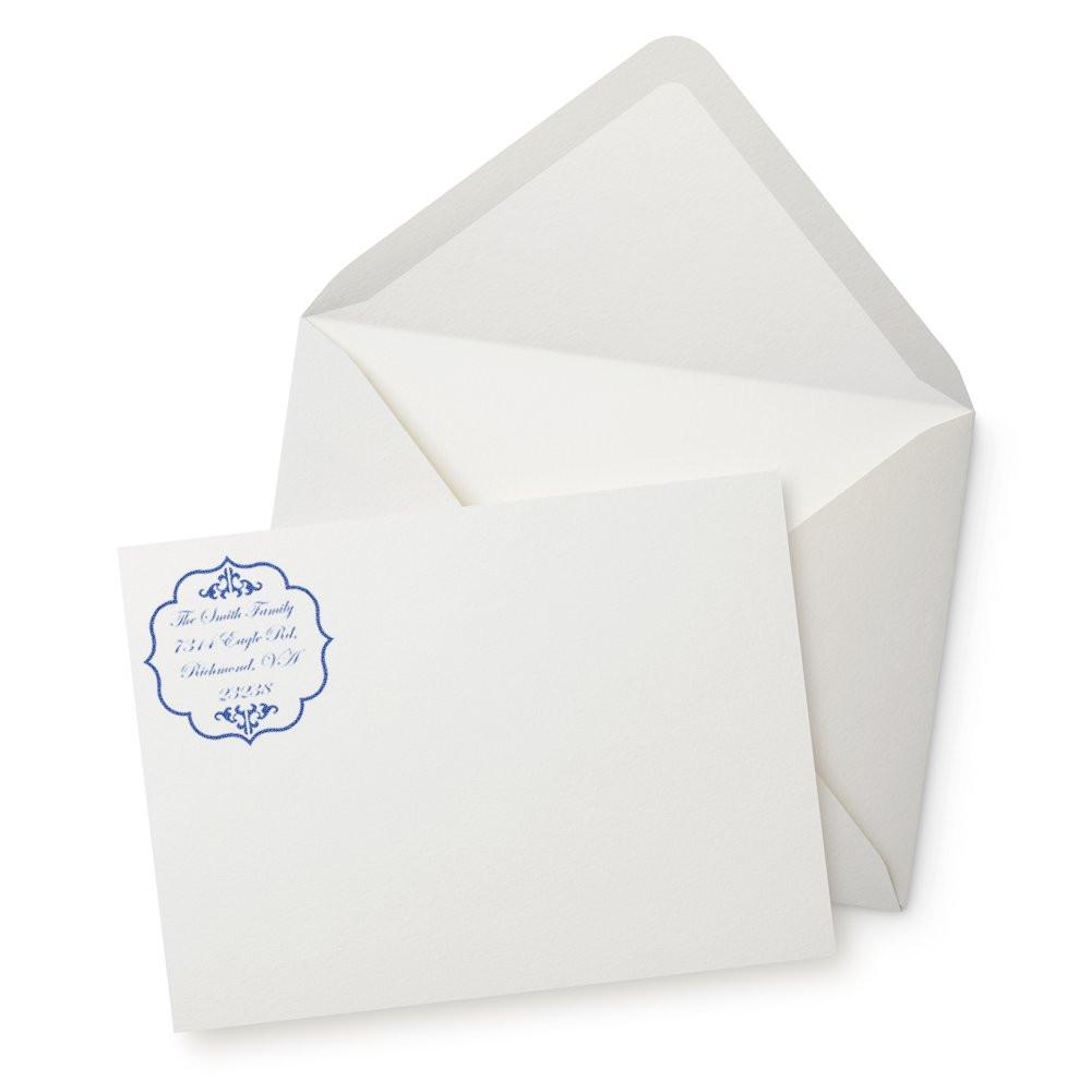 Custom return address rubber stamp on white envelope and card for wedding invitations and mailings.
