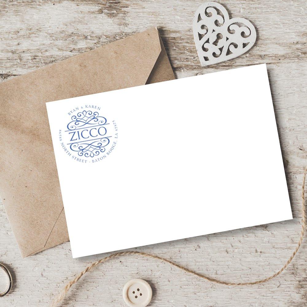 Custom rubber stamp monogram on wedding stationery, shown on a white card with kraft envelope for personalized branding.