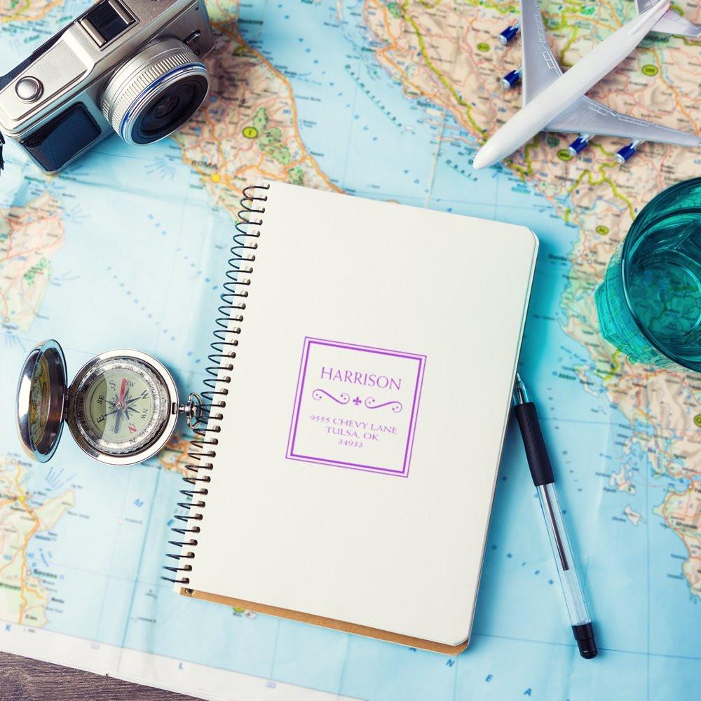 Travel planner notebook on world map with compass, airplane, cameraideal for trip planning, itinerary notes, and directions.