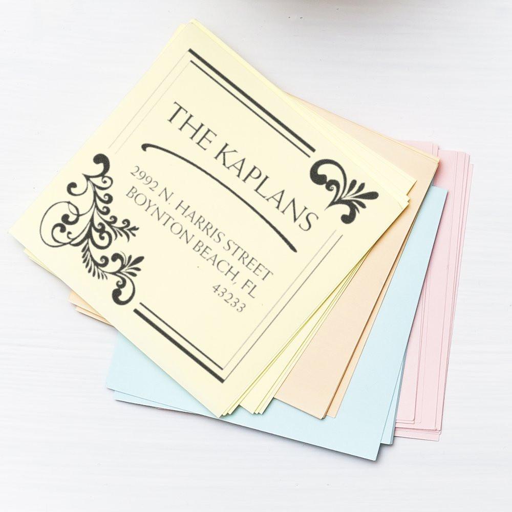 Custom rubber stamp design for wedding invitations and return addressing on pastel stationery, featuring an elegant family name and address.