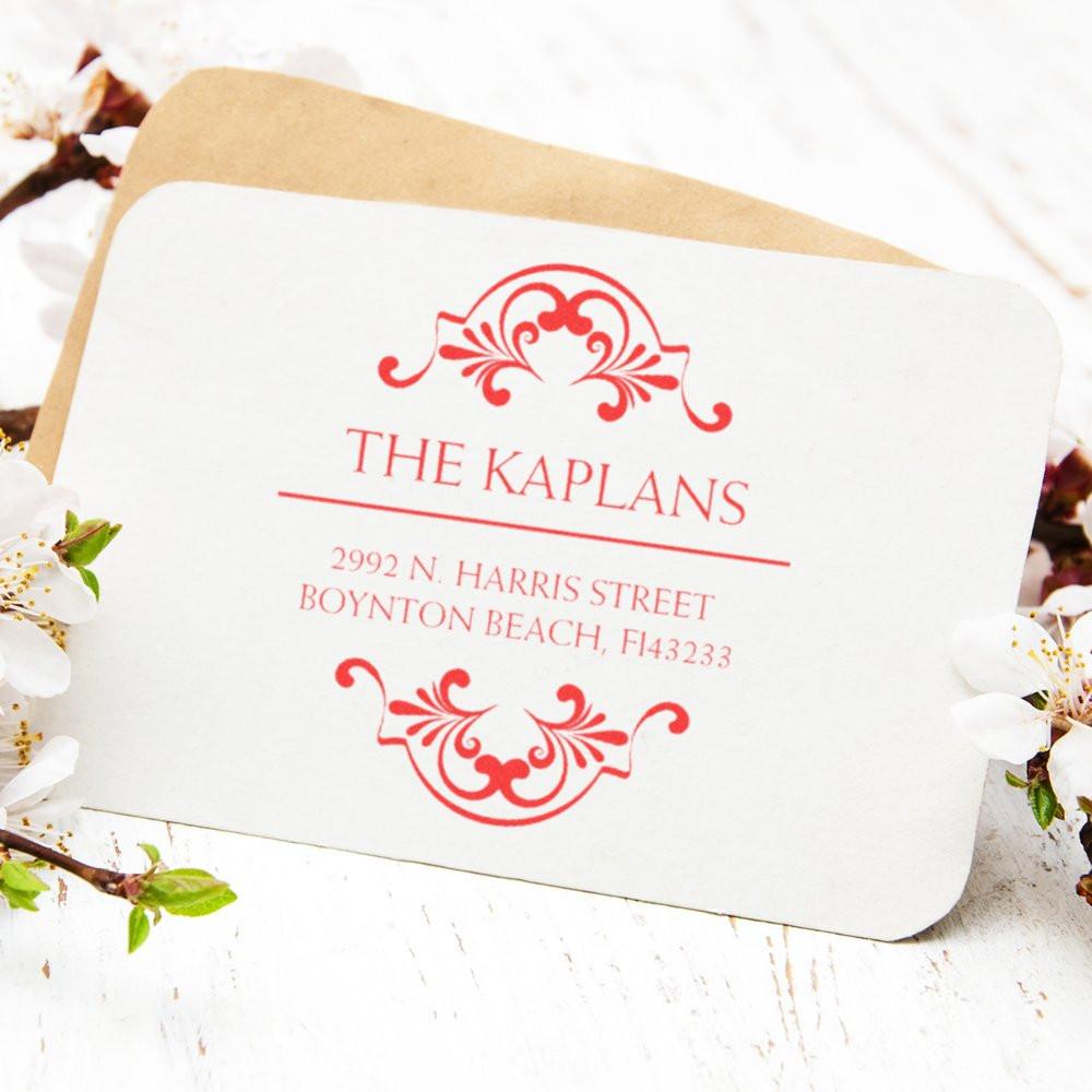 Personalized return address rubber stamp with floral design, featuring The Kaplans family name on a wedding envelope.