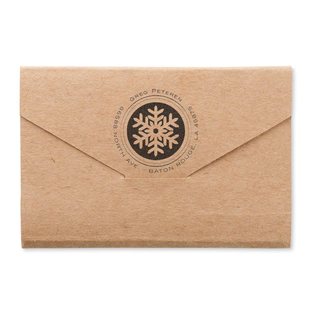 Branded kraft envelope with circular snowflake logo for Greg Petersen, Baton Rouge, Louisiana mailing.