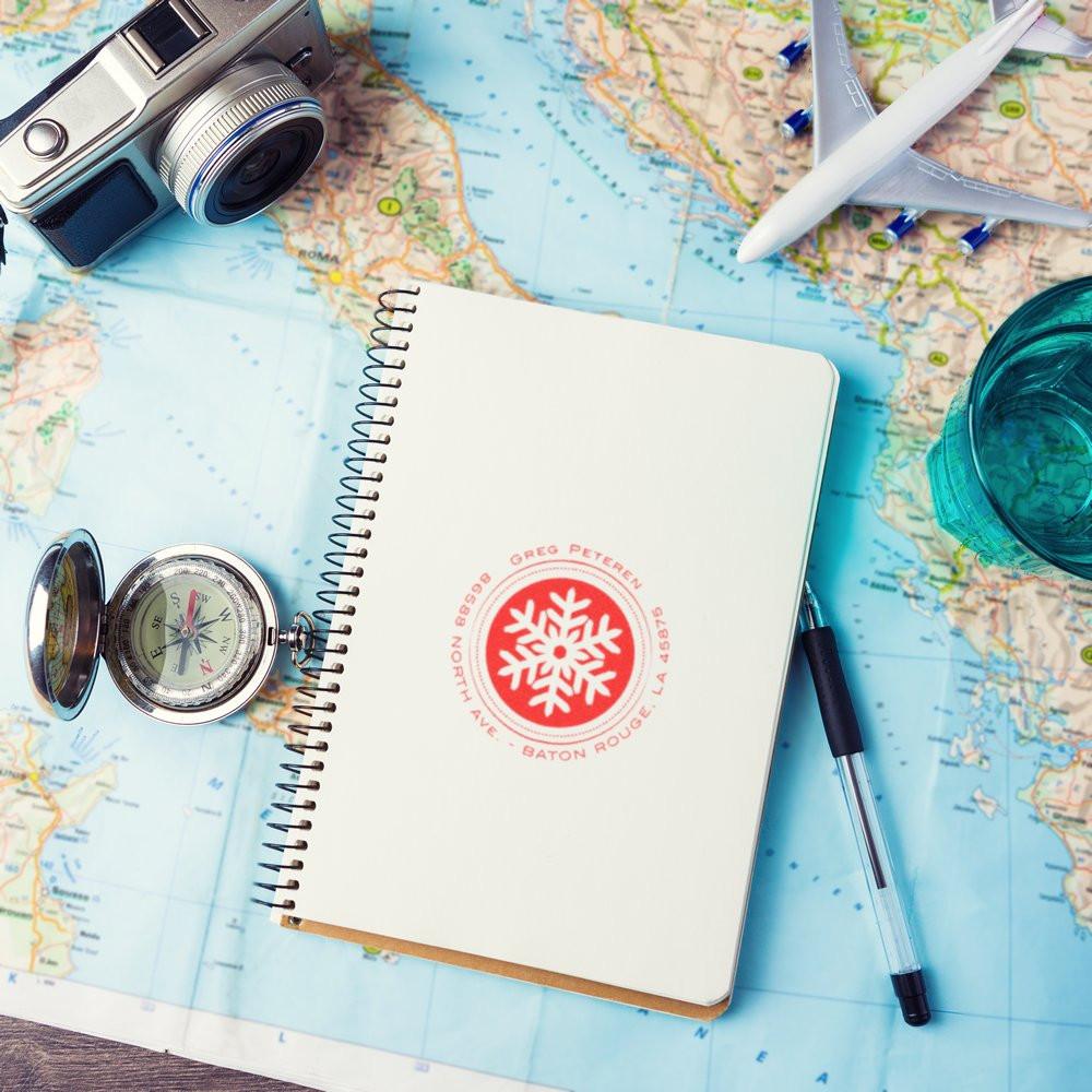 Travel planning flat lay: notebook, compass, camera and airplane on a world map for vacation route ideas