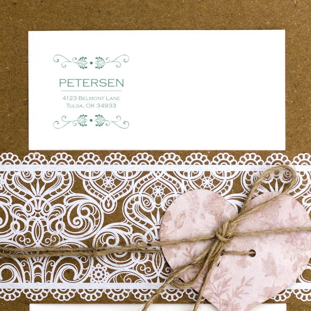 Personalized return address rubber stamp on wedding stationery with decorative lace and heart detail