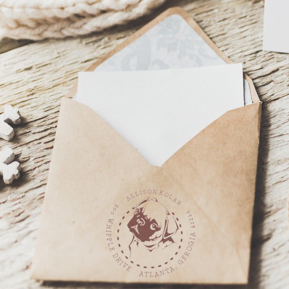 Custom return address rubber stamp on kraft envelope for personalized wedding or business mail.