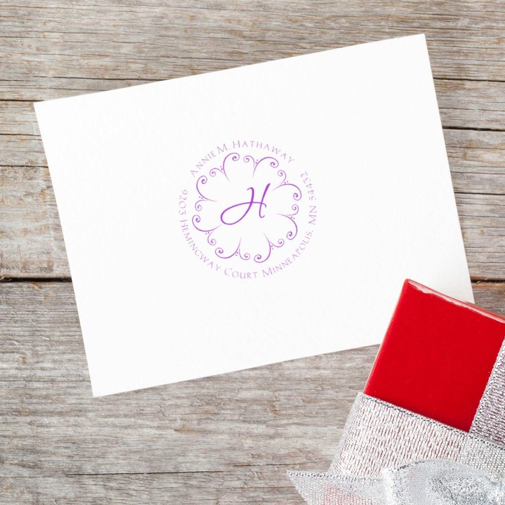 Custom monogram return address rubber stamp on white card, ideal for wedding stationery and personalized envelopes.