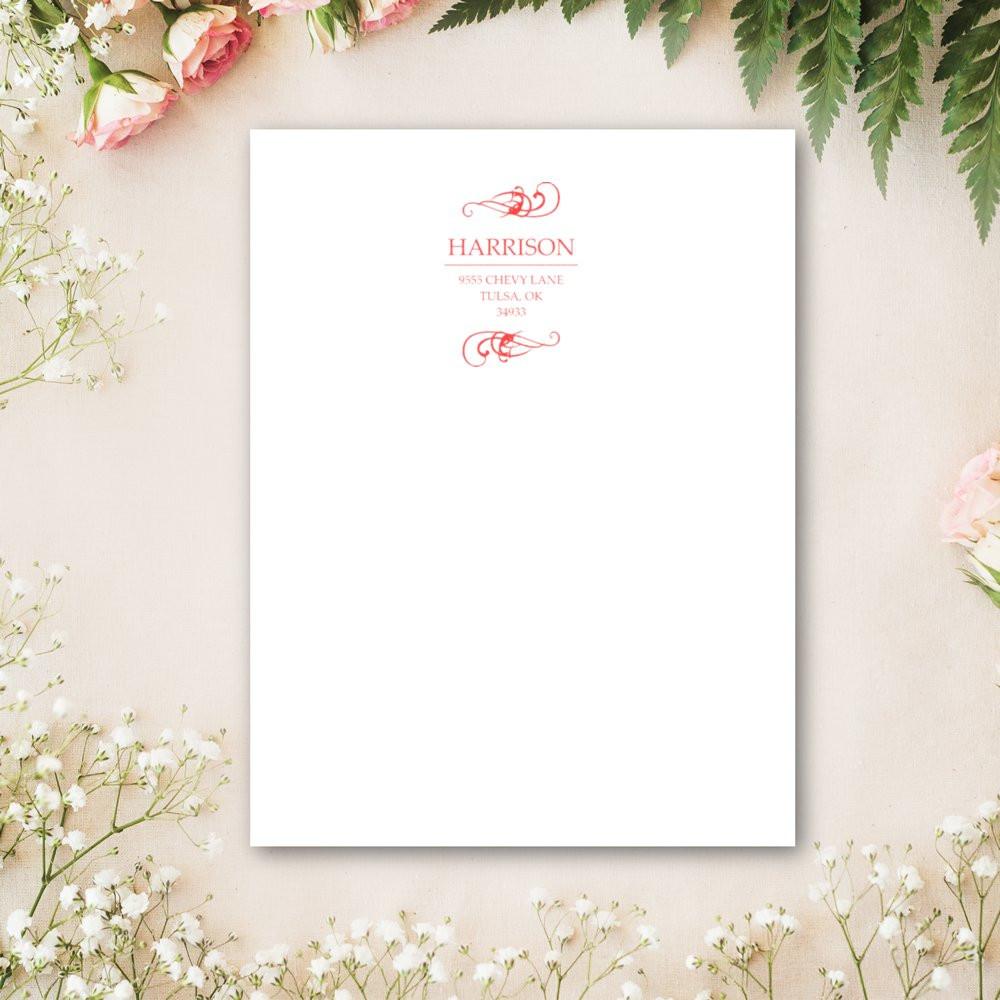 Custom Harrison return address rubber stamp on white stationery, featuring elegant pink monogram and floral accent design.
