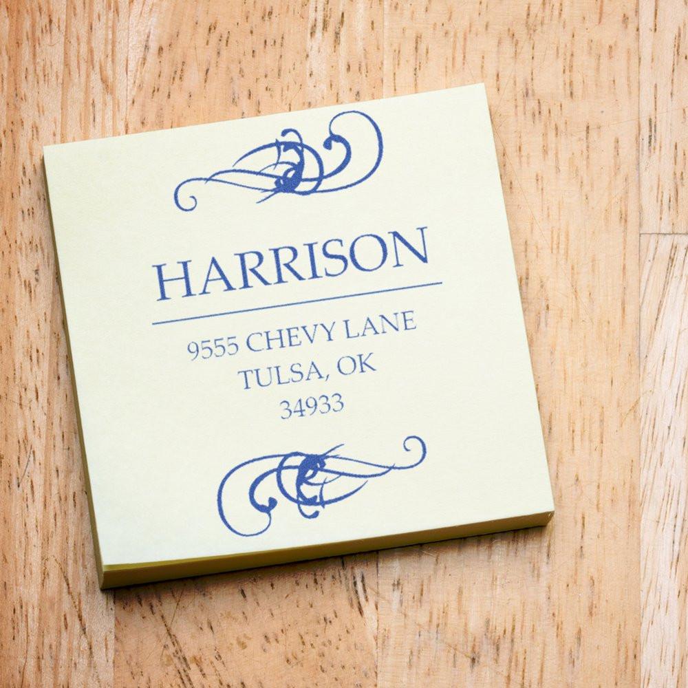 Custom rubber return address stamp impression with name, address, and decorative flourishes on sample cardstock.