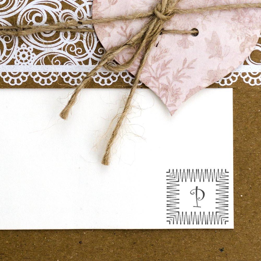 Personalized monogrammed greeting card letter P on blank paper with floral patterned envelope and twine, rustic stationery.